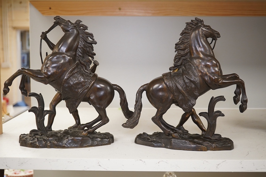 After Guillaume Coustou, a pair of dark patinated bronzes, The Marly Horses, 19th century, 25.5cm high. Condition - good.